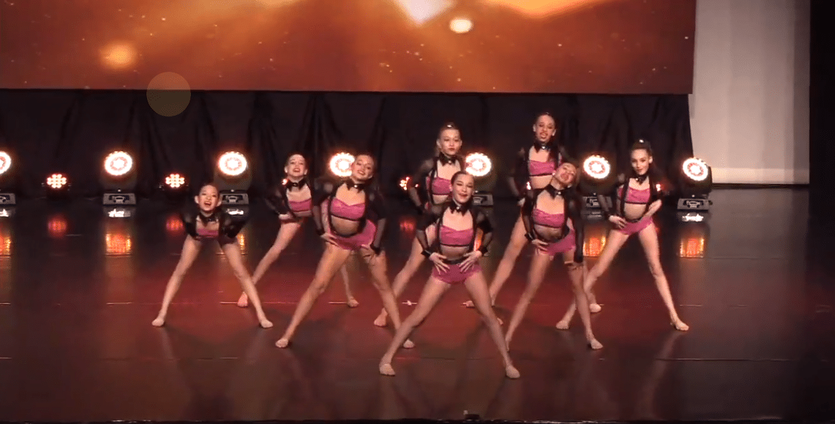 Competitive jazz dancers on stage at dance competition in richmond hill